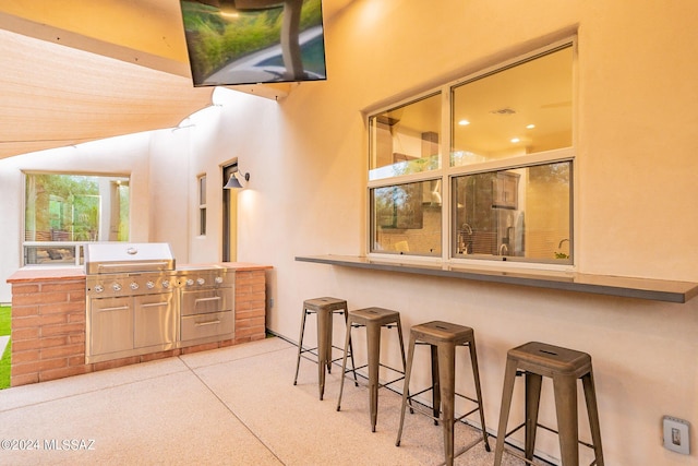 view of patio with outdoor wet bar and an outdoor kitchen