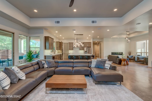 living room with a fireplace and ceiling fan