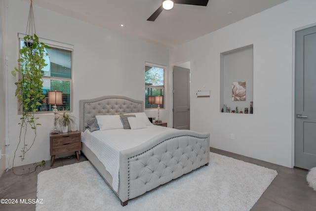 bedroom with concrete flooring and ceiling fan