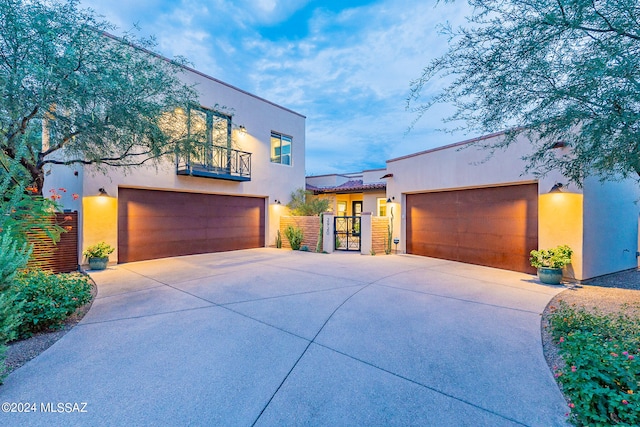 view of front of home featuring a garage and a balcony