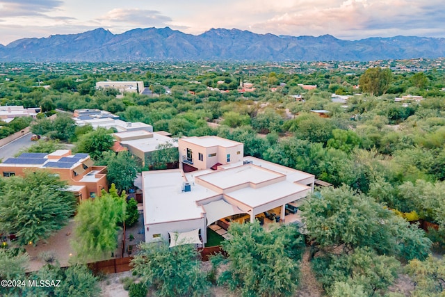 aerial view at dusk featuring a mountain view