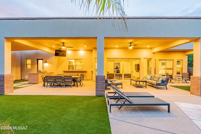 view of patio with an outdoor living space, an outdoor bar, and ceiling fan