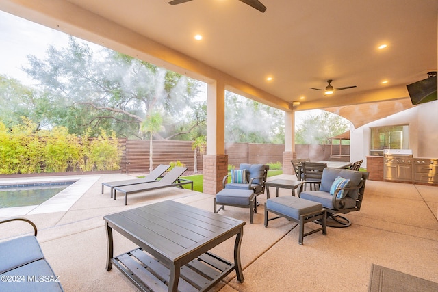 view of patio / terrace with a fenced in pool, area for grilling, and ceiling fan