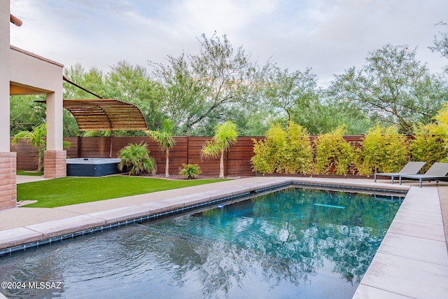 view of swimming pool featuring a lawn