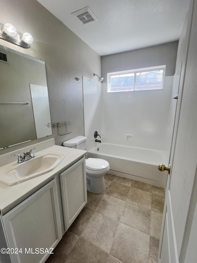 bathroom with bathtub / shower combination, visible vents, a textured wall, toilet, and vanity