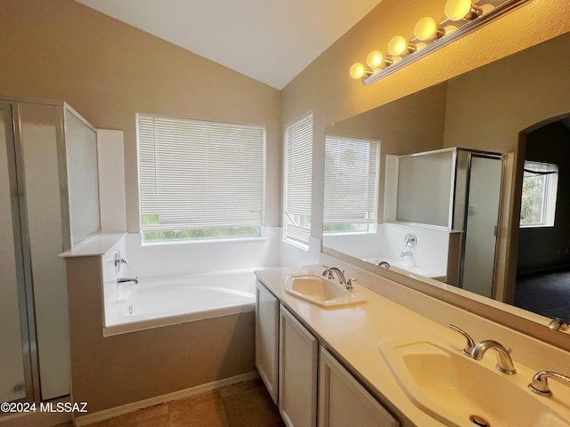 bathroom with vaulted ceiling, a stall shower, a sink, and a bath