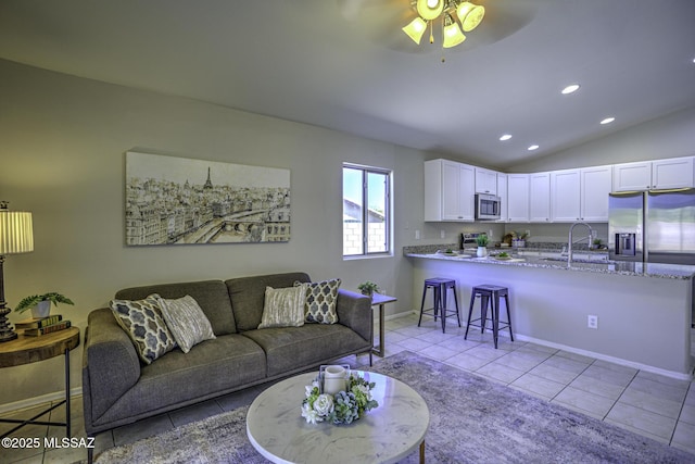 living room with light tile patterned floors, ceiling fan, vaulted ceiling, recessed lighting, and baseboards