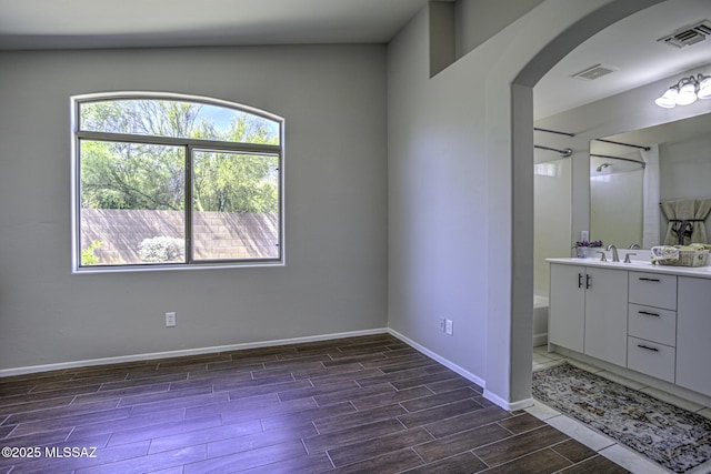 full bathroom with vanity, visible vents, baseboards, and wood finished floors