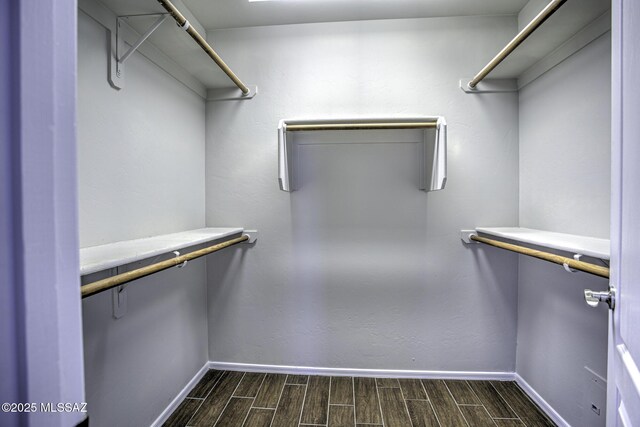 spacious closet with wood finish floors