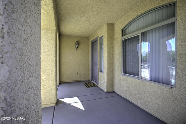 view of exterior entry featuring stucco siding