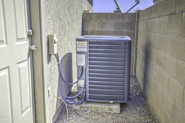 exterior details with cooling unit and stucco siding