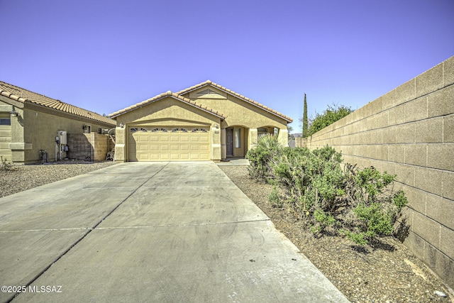 single story home with concrete driveway, stucco siding, fence, and a garage