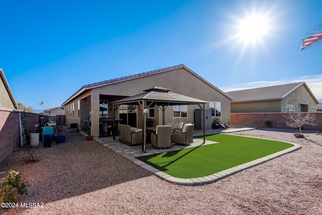 back of house with a gazebo and a patio area