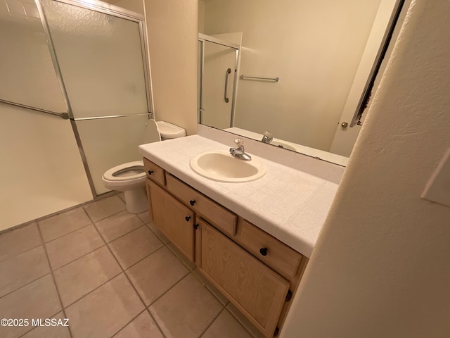 bathroom featuring an enclosed shower, vanity, tile patterned floors, and toilet