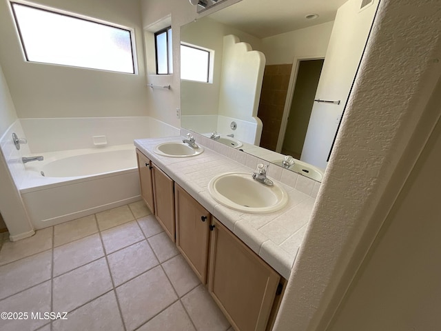 bathroom featuring tile patterned floors, a bathtub, and vanity