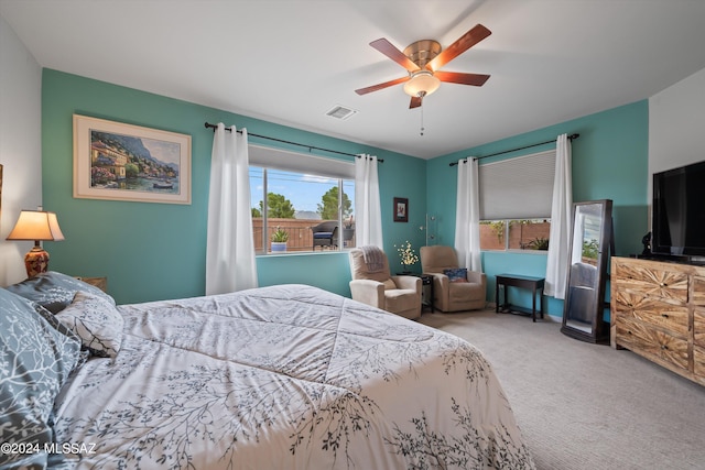 bedroom with carpet, visible vents, and a ceiling fan