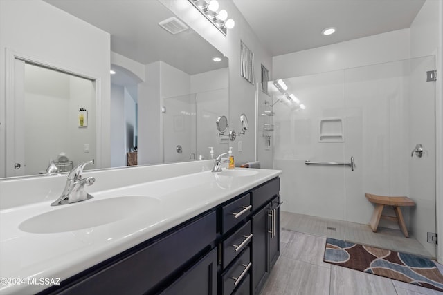 full bath with visible vents, a sink, and an enclosed shower