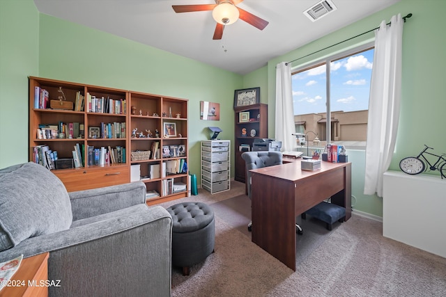 office featuring carpet, visible vents, and ceiling fan