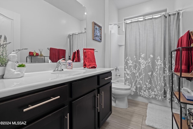 bathroom with vanity, toilet, and shower / bath combo with shower curtain