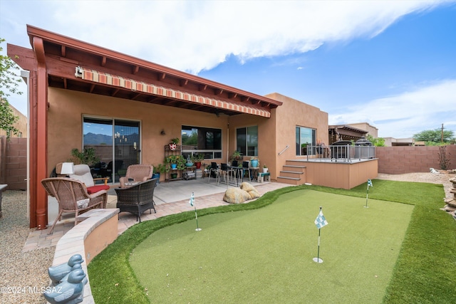 back of house featuring a patio area, fence, outdoor lounge area, and stucco siding