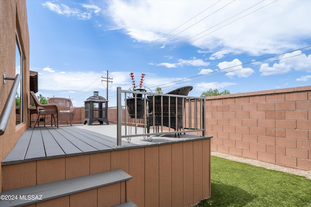 wooden terrace featuring fence