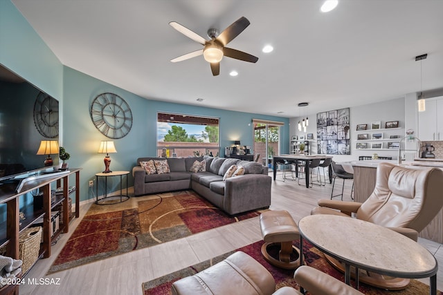 living room with ceiling fan and recessed lighting