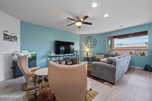 living room featuring a ceiling fan, recessed lighting, visible vents, and baseboards