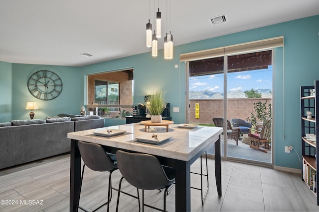 dining space featuring baseboards, visible vents, and a healthy amount of sunlight