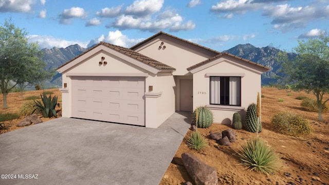 view of front of home with a mountain view and a garage