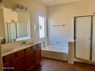 bathroom featuring independent shower and bath, vanity, and wood-type flooring