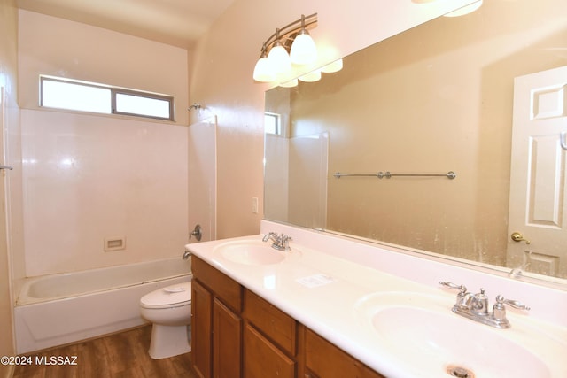 full bathroom with toilet, hardwood / wood-style flooring, tub / shower combination, and vanity