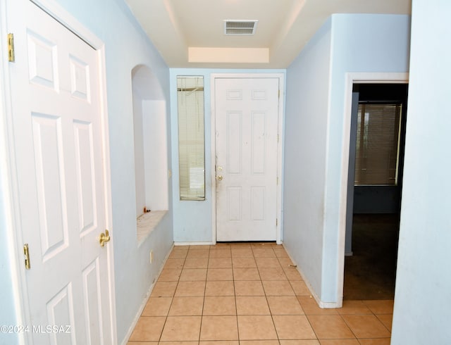 doorway with light tile patterned floors