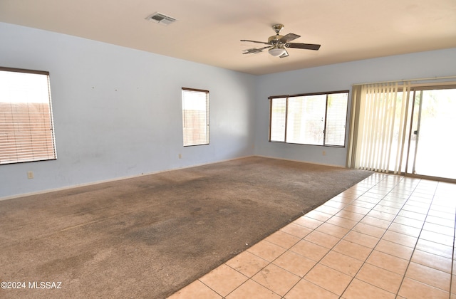 unfurnished room with light carpet and ceiling fan