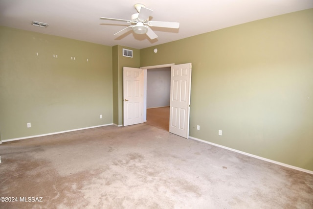 spare room with light colored carpet and ceiling fan