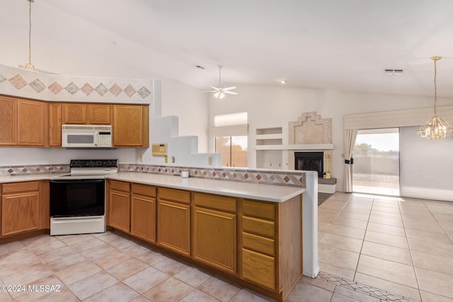 kitchen featuring light countertops, ceiling fan with notable chandelier, electric range, a peninsula, and white microwave