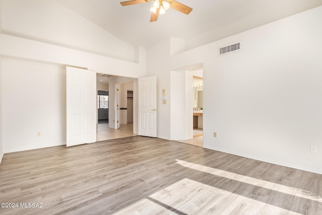spare room featuring a ceiling fan, high vaulted ceiling, light wood finished floors, and visible vents