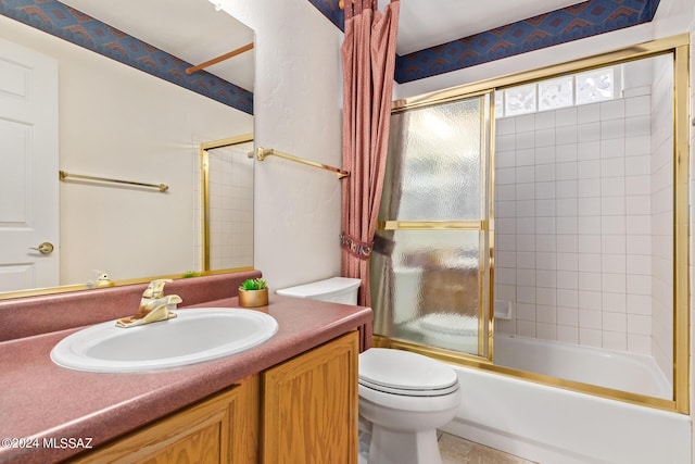 bathroom with toilet, vanity, and bath / shower combo with glass door