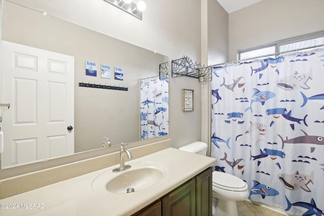 bathroom featuring curtained shower, vanity, toilet, and tile patterned floors