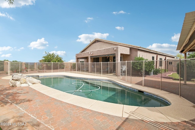 view of swimming pool with a patio area