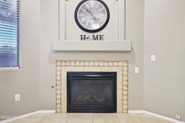 room details with a tiled fireplace and tile patterned floors