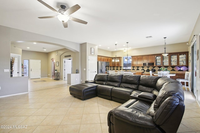 tiled living room featuring ceiling fan