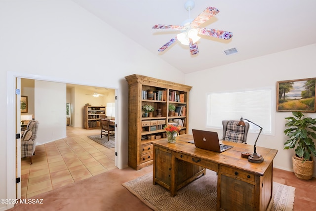 home office featuring light tile patterned flooring, ceiling fan, visible vents, and vaulted ceiling