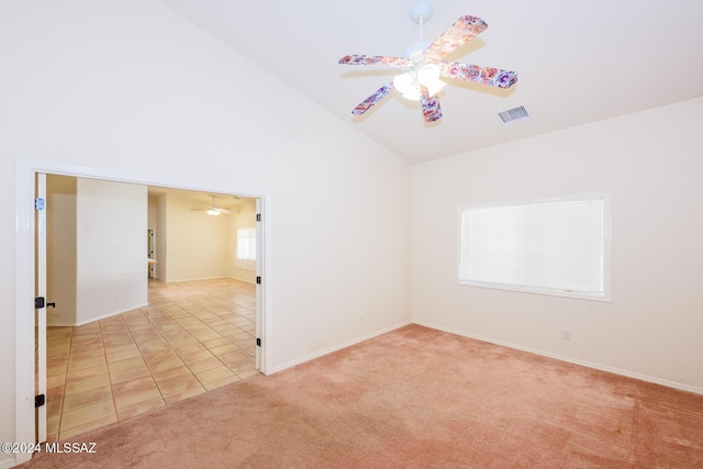 spare room featuring light colored carpet, ceiling fan, visible vents, and baseboards