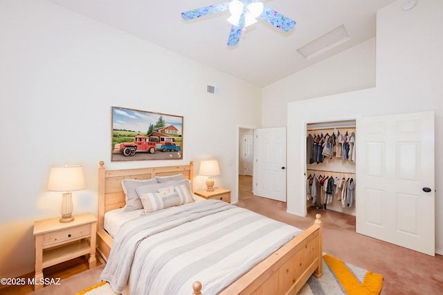 bedroom featuring visible vents, a closet, attic access, high vaulted ceiling, and light colored carpet