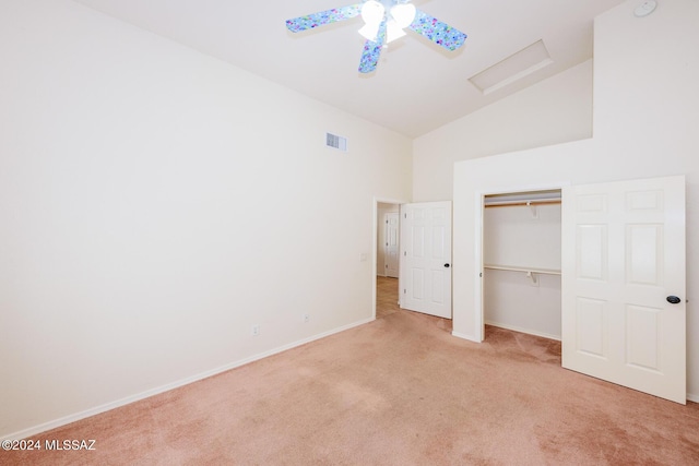 unfurnished bedroom featuring visible vents, carpet floors, baseboards, attic access, and high vaulted ceiling
