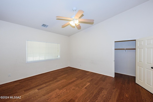 unfurnished bedroom featuring visible vents, a closet, lofted ceiling, wood finished floors, and a ceiling fan