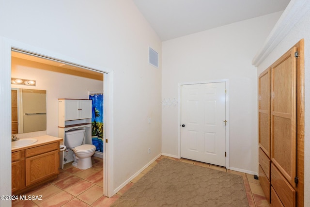 interior space featuring vanity, toilet, tile patterned floors, curtained shower, and visible vents