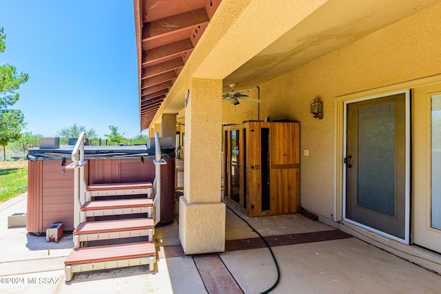 view of patio featuring ceiling fan and a hot tub