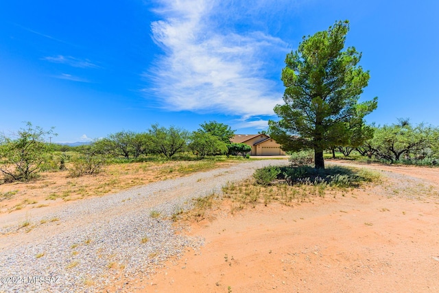 view of road with gravel driveway