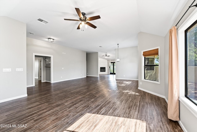 unfurnished living room featuring ceiling fan, dark wood-type flooring, and lofted ceiling